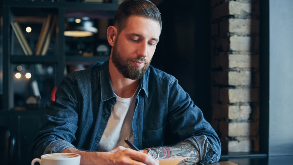 Man writing in journal